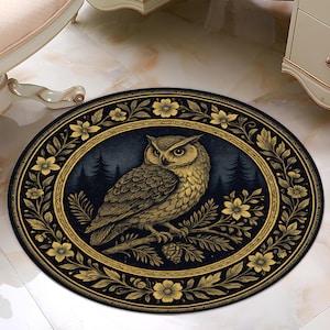 May include: An oval-shaped rug featuring a detailed illustration of an owl perched on a branch. The owl is depicted in shades of gold and brown against a dark blue background with a forest silhouette. The rug is framed by a gold floral border.