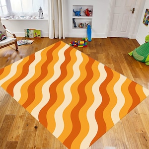 May include: A rectangular rug with a retro wavy pattern in shades of orange and cream. The rug is placed on a wooden floor in a room with a window, chair, and toys. The design features alternating vertical stripes of varying widths.