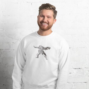 May include: White sweatshirt with a black and white illustration of a person in a cape and armor.