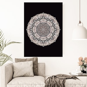 May include: A white and pink mandala design on a black background. The mandala is intricate and detailed, with a circular pattern of flowers and leaves. The design is framed by a white border.