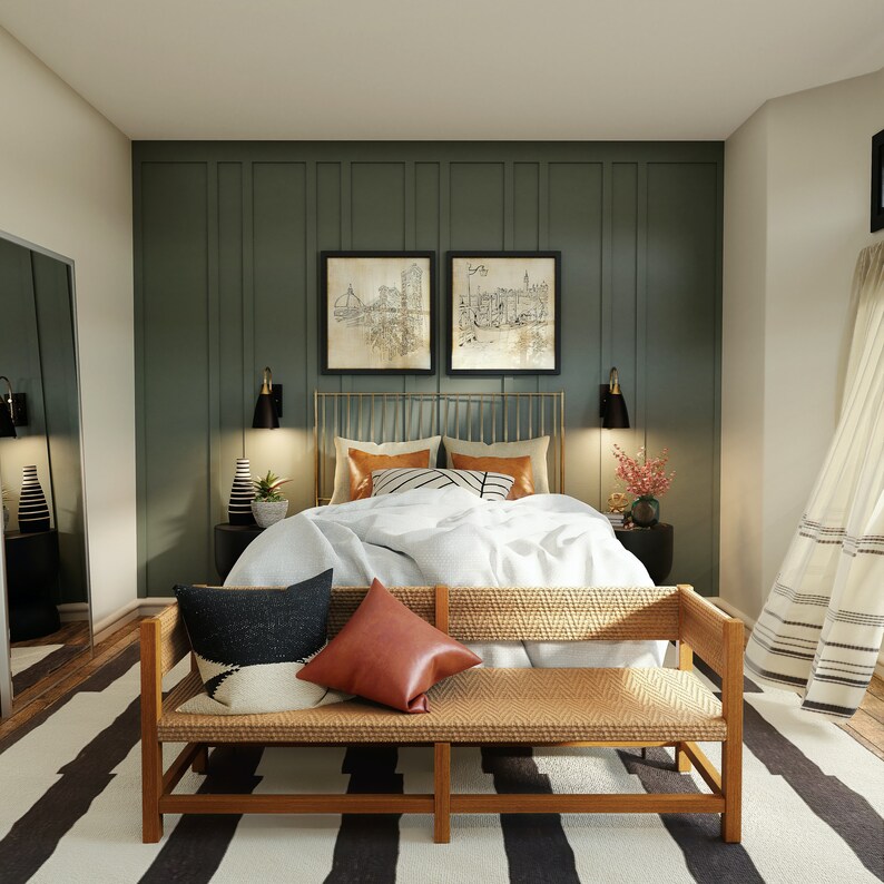 May include: A bedroom with a green wall and a bed with a white duvet and a woven bench at the foot of the bed. The bed has a gold metal frame and a white and black patterned throw pillow.