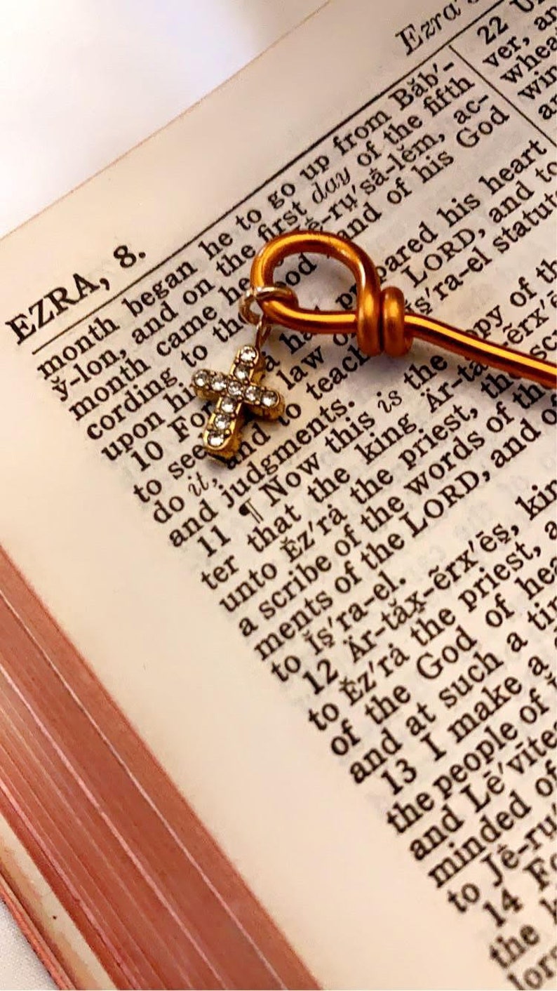 The cross charm is added to the top of each bookmark, adding an elegant touch.