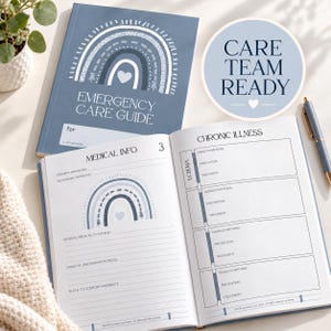 May include: A blue Emergency Care Guide notebook with a white rainbow graphic and heart icon. The open pages feature sections for Medical Info, Chronic Illness, Eczema, signs, symptoms, prevention, and treatment. A pen rests nearby.