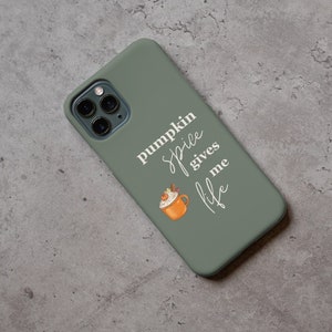 May include: A green phone case with a white design that says "pumpkin spice gives me life" and a cartoon image of a pumpkin spice latte.