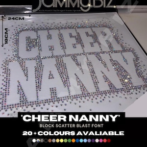 May include: A rhinestone heat transfer design featuring the words CHEER NANNY in a block font. The letters are filled with iridescent crystals on a white backing. The design measures 24 cm by 18 cm. The text JAMMY.BIZ appears at the top.