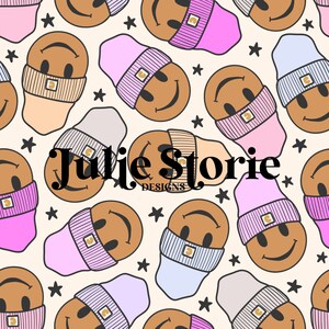 May include: A seamless pattern featuring smiling faces wearing various colored beanies. The background is a light beige color with small black stars scattered throughout. The text "Julie Storie Designs" is centered in the pattern.