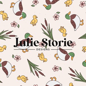 May include: A seamless pattern featuring ducks, ducklings, cattails and flowers on a light pink background. The text "Julie Storie Designs" is centred on the pattern.