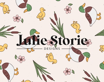 May include: A seamless pattern featuring ducks, ducklings, cattails, and flowers on a light pink background. The text "Julie Storie Designs" is centered on the pattern.
