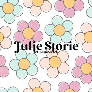 May include: A seamless pattern featuring pastel pink, blue, and cream daisy flowers with yellow centres. The text "Julie Storie Designs" is centred in the image.