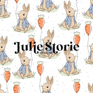 May include: A seamless pattern featuring a cartoon bunny wearing a blue jacket and holding a carrot balloon. The background is white with a subtle speckled texture. The text "Julie Storie Designs" is centered in the pattern.