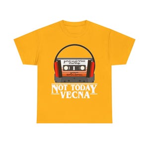May include: Mustard yellow t-shirt with a retro cassette tape design. The tape has the text "guns and roses starship" and "prince duran duran". Below the tape is the text "NOT TODAY VECNA".