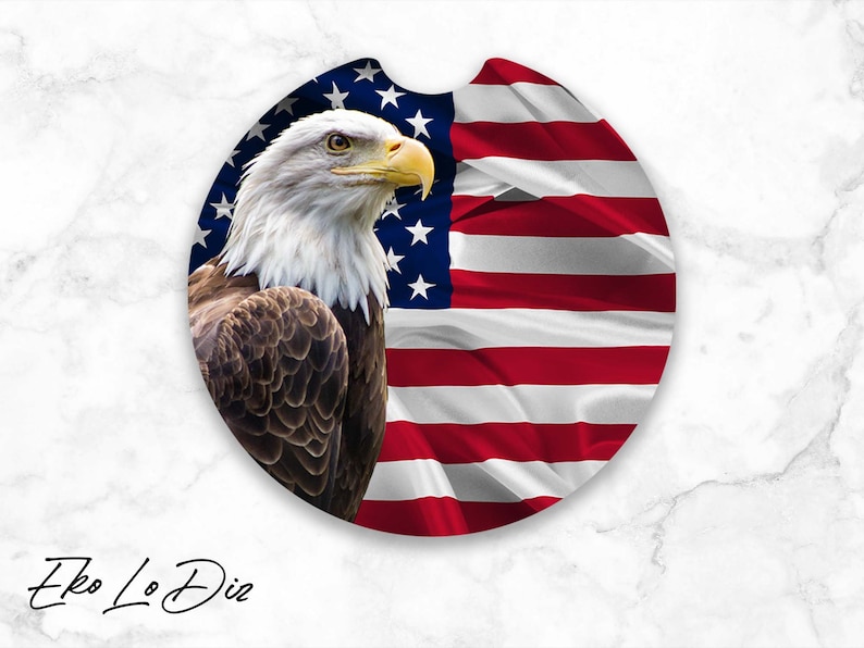 May include: A round coaster featuring a bald eagle with a white head and brown feathers, perched in front of a red, white, and blue American flag.