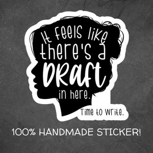 May include: Black and white sticker with a silhouette of a person's head and the text "It feels like there's a draft in here. Time to write."  100% HANDMADE STICKER!