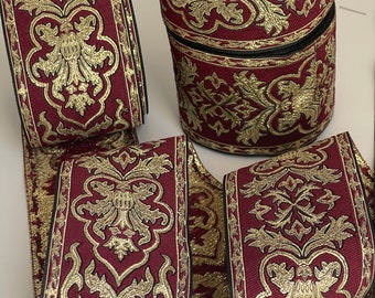 May include: Burgundy and gold trim ribbon with a repeating floral pattern. The ribbon is approximately 1 inch wide.