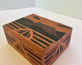 Caja de cerámica rústica tallada hecha a mano para guardar objetos pequeños.