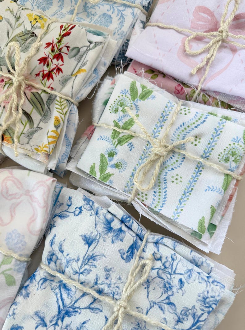 Puede incluir: Conjunto de paquetes de tela atados con cuerda. Las telas presentan estampados florales y bot&aacute;nicos en varios colores, incluyendo rojo, amarillo, azul y rosa. Algunos paquetes tienen dise&ntilde;os de lazo.