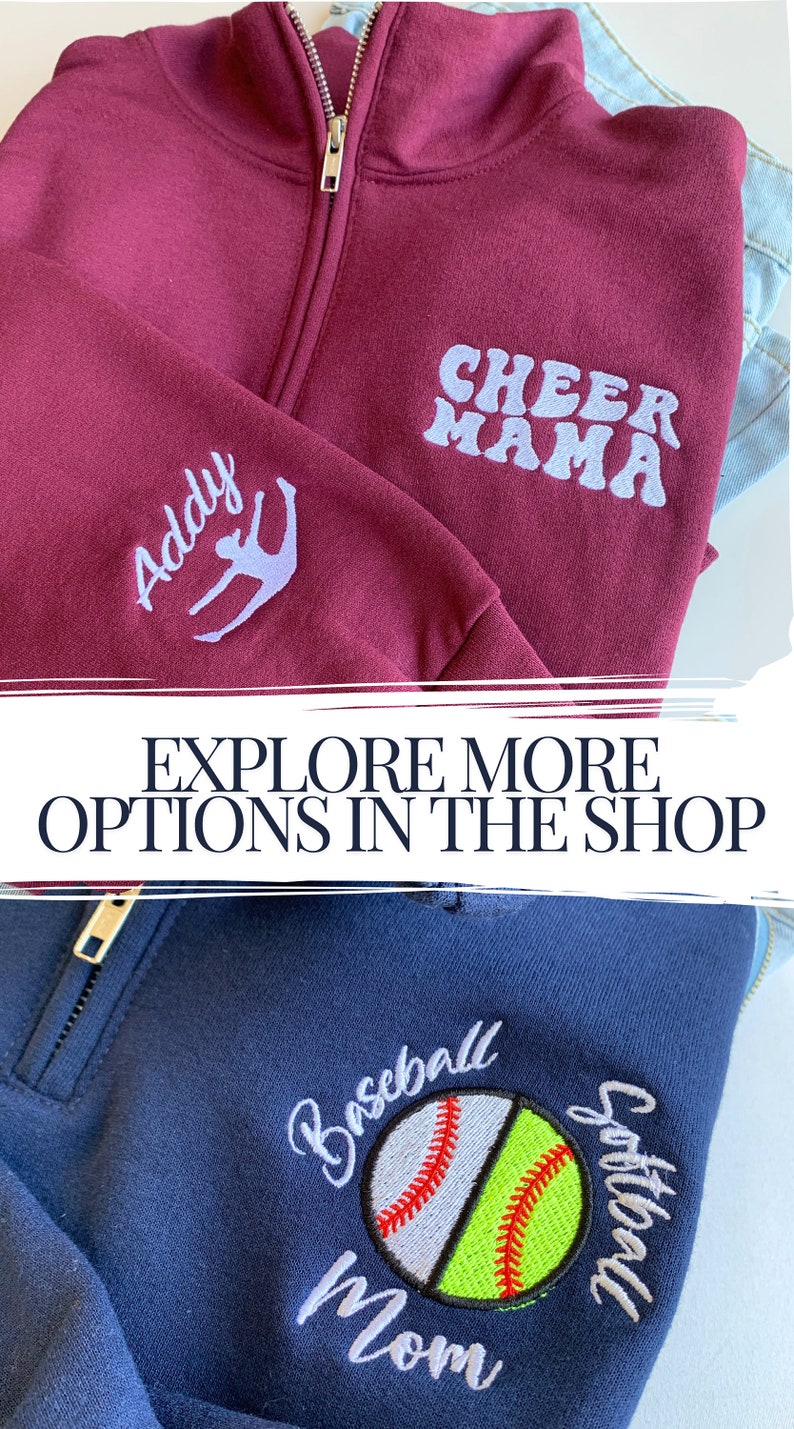 May include: Two zippered sweatshirts with embroidered designs. The first sweatshirt is maroon with "Cheer Mama" and a stylized figure on the front. The second sweatshirt is navy blue with a baseball and softball design and the text "Baseball Softball Mom" on the front.