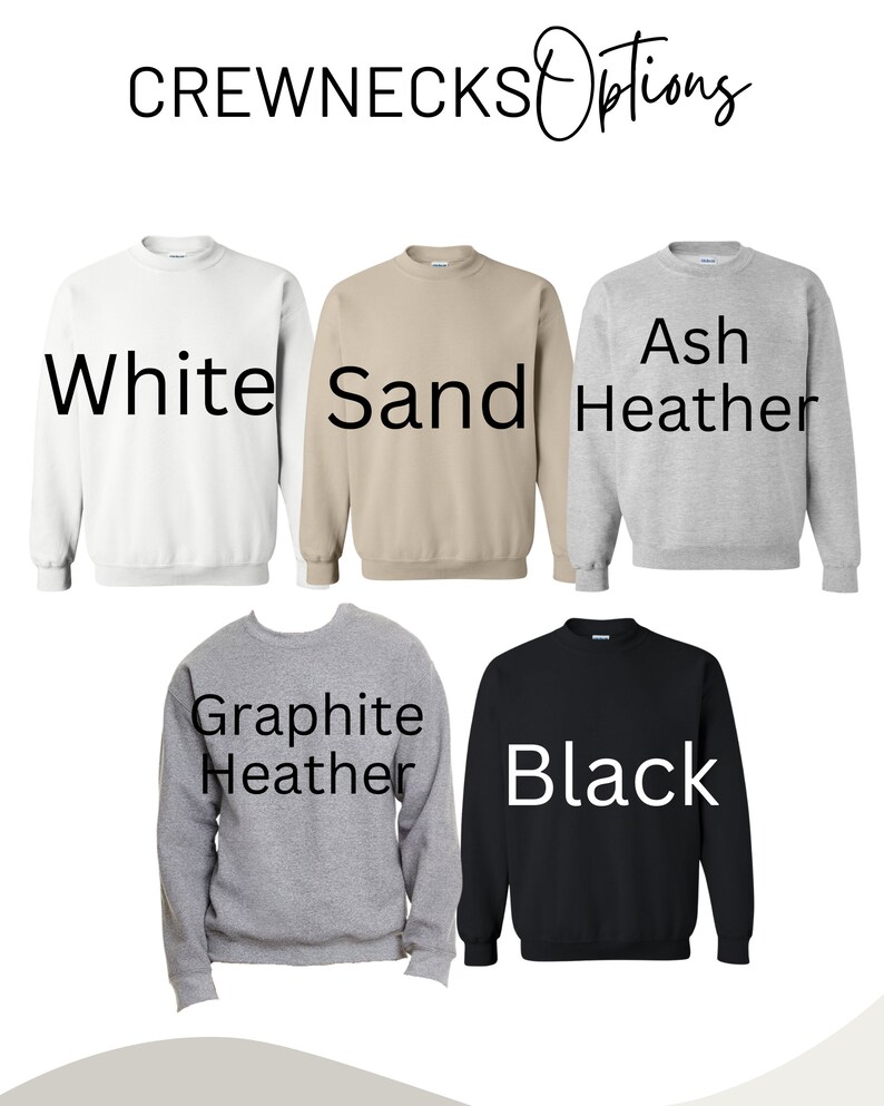 May include: Five crewneck sweatshirts in different colors: white, sand, ash heather, graphite heather, and black.  The sweatshirts are laid out flat on a white background.