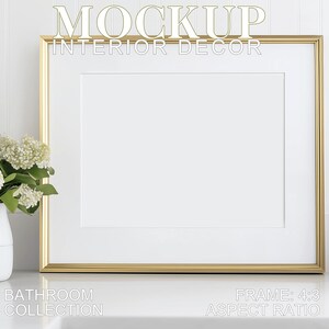 May include: A gold picture frame with a white mat and a white background. The frame is sitting on a white countertop. The text "MOCKUP INTERIOR DECOR" is at the top of the frame. The text "BATHROOM COLLECTION" is at the bottom left of the frame. The text "FRAME 4:3 ASPECT RATIO" is at the bottom right of the frame.