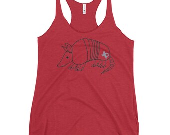 May include: Red racerback tank top featuring a hand-drawn armadillo illustration. The armadillo has a gray outline and a Texas-shaped design on its side. The tank top is made of a soft, lightweight material.