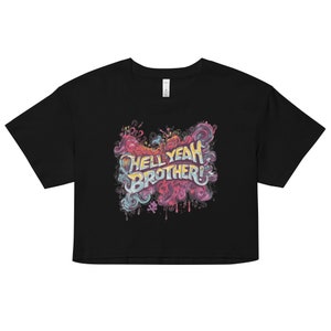 May include: Black crop top featuring the text "HELL YEAH BROTHER!" in a colourful, graffiti-style design. The graphic includes swirling pink, blue, and yellow accents, creating a vibrant look. A casual and stylish apparel item.