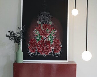 May include: A framed art print featuring a floral and skeletal design in red, green, and white on a black background. The artwork is displayed on a red shelf with a green vase and black plant. A modern black light fixture with two white globe lights hangs nearby.