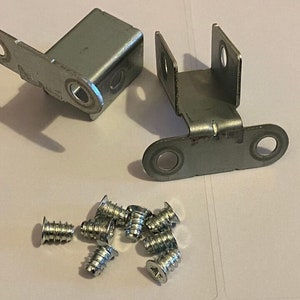 May include: Two silver metal brackets with two holes each and a set of ten silver screws.