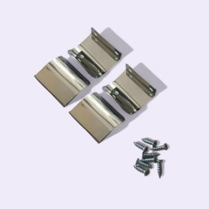 May include: Four shiny, silver-colored metal brackets with mounting tabs and a small pile of silver screws are arranged on a white background. The brackets have a curved design and reflect the light.