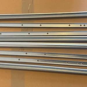 May include: A set of eight silver metal drawer slides, with a few small silver screws.