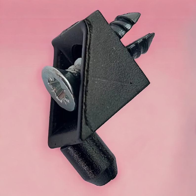 May include: Black plastic corner bracket with a silver screw. The bracket has a triangular shape and a small, round, black knob on the bottom.