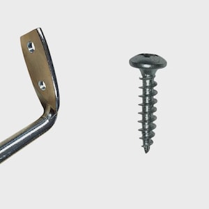 May include: A shiny metal bracket with two screw holes and a curved design, next to a dark gray screw with a round head and a threaded shaft. The hardware is set against a light gray background.