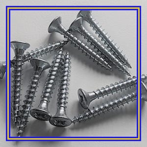 May include: Close-up of several silver wood screws with flat heads. The screws are arranged in a scattered pattern, showcasing their spiral threads and pointed tips. The screws are designed for woodworking and construction projects.