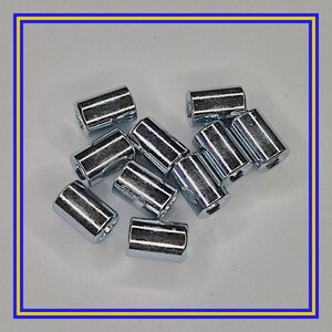 May include: A group of shiny, cylindrical metal objects with a silver finish. The objects are scattered, each with a slightly tapered shape. The image is framed with a blue and yellow border.