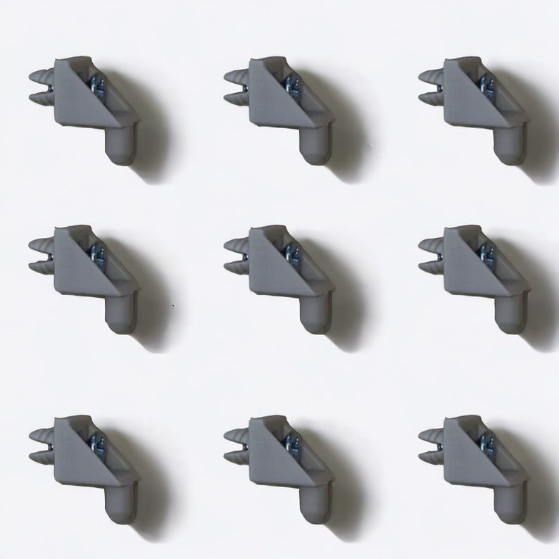 May include: Nine gray plastic corner brackets with a screw hole on each. The brackets are arranged in three rows of three.