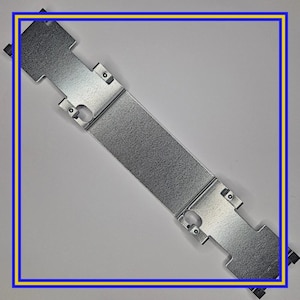 May include: A silver metal bracket with a rectangular central section and tabs at each end. The bracket features several holes and is designed for mounting or support. The item is shown against a plain background.