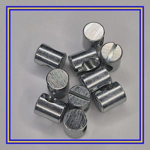 May include: A collection of silver-colored metal furniture connectors. The connectors have various shapes, including cylindrical and barrel-shaped, with slotted or threaded designs. The hardware is displayed against a white background, framed by a blue and yellow border.