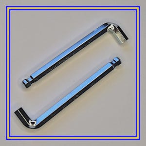 May include: Two shiny, silver Allen wrenches, also known as hex keys, are displayed against a neutral background. The tools are L-shaped, with one end featuring a hexagonal head for inserting into a screw and the other end providing leverage.