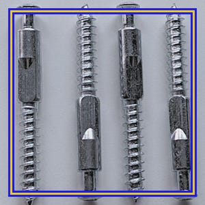 May include: Four silver furniture connector bolts with a screw thread and a central barrel. Each bolt has a slot for a screwdriver and a triangular opening. The bolts are arranged vertically against a white background.