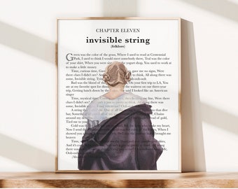 May include: A framed print of a song lyric from Taylor Swift's album folklore. The lyrics are for the song "invisible string" and feature a watercolour illustration of a woman in a black coat.