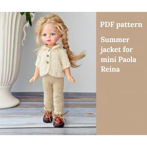 May include: A doll dressed in a cream-coloured knitted jacket and trousers, paired with brown shoes. The doll has blonde hair styled in a braid. The text reads "PDF pattern Summer jacket for mini Paola Reina."
