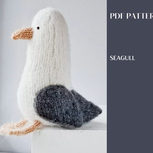May include: Knitted seagull amigurumi toy pattern. The pattern is for a white seagull with a grey wing and a peach-coloured beak. PDF PATTERN SEAGULL.