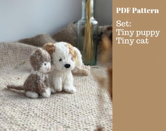 May include: A crocheted tiny puppy and cat set. The puppy is white with brown spots, and the cat is brown and white. The text on the right says "PDF Pattern Set: Tiny puppy Tiny cat."