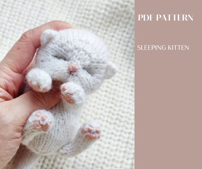 A cute fluffy kitten sleeps in my hand. You can knit the same according to my pattern.