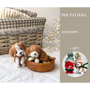 May include: Two crocheted tiny puppy figures, one standing and one in a wooden bowl. The puppies are brown and white with floppy ears. The image also includes a basket and text that reads "PDF PATTERN TINY PUPPY + GIFT".