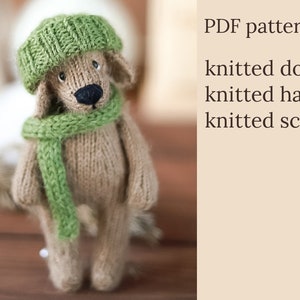 Niedlicher gestrickter Welpe mit Mütze und Schal. Strickanleitung in Englisch und Russisch. Amigurumi Spielzeug.