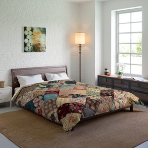 May include: A patchwork quilt with a variety of floral and geometric patterns in shades of red, blue, green, and brown. The quilt is on a bed with white pillows and a wooden headboard.