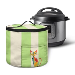 May include: A green and white striped insulated bag with a black handle and a colorful cat design on the front. A stainless steel Instant Pot is next to the bag.