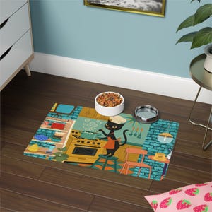 May include: A rectangular pet food mat with a retro kitchen scene featuring a black cat chef wearing a chef's hat and apron. The mat has a blue brick wall design, a stove, and a small chair. A white bowl and a silver bowl are on the mat.