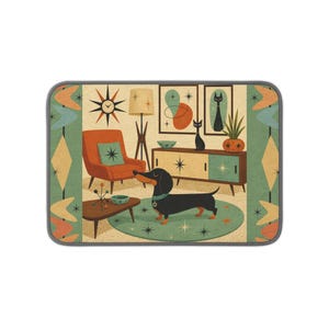 May include: A rectangular mat featuring a mid-century living room illustration with a black dachshund, an orange armchair, a teal rug, a wooden sideboard, a floor lamp, and a starburst clock, framed by a border of orange and teal boomerang shapes.