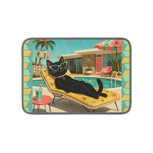 May include: A rectangular mat featuring a black cat wearing teal glasses, lounging on a yellow sun lounger by a swimming pool. The scene includes a pink umbrella, a small red table with a drink, palm trees, and a sign that reads POOL.